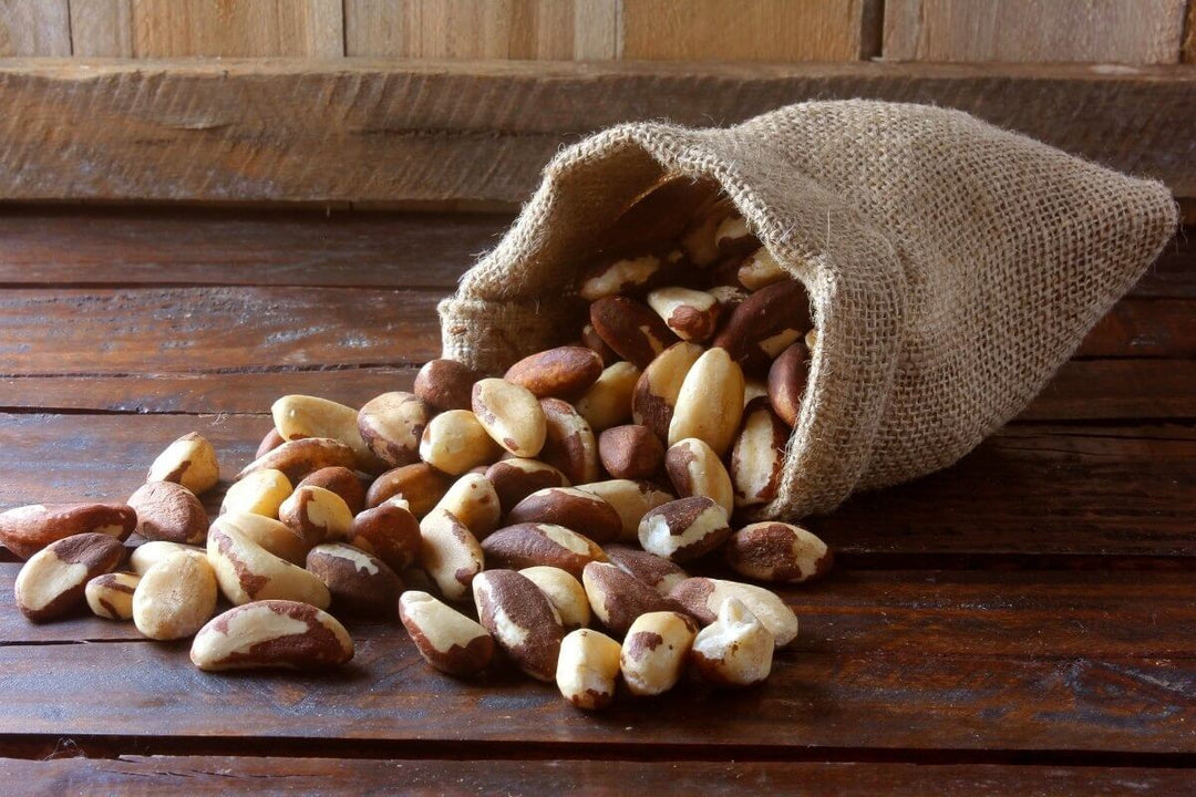 Brazil nuts spilling out of a linen bag, a natural source of selenium