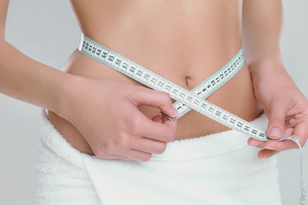 women measuring waist 