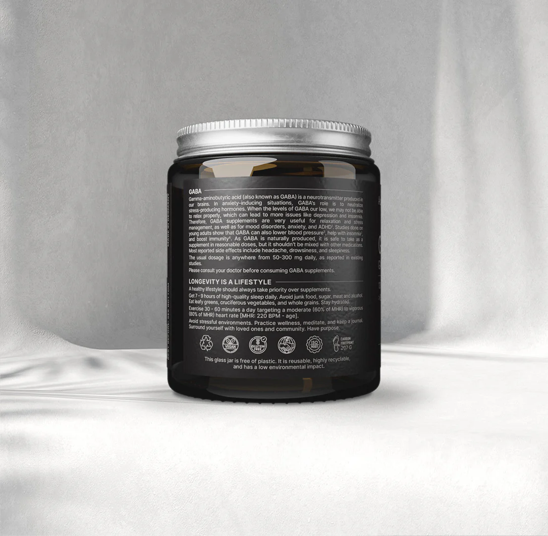 Black supplement jar with silver lid on a gray background