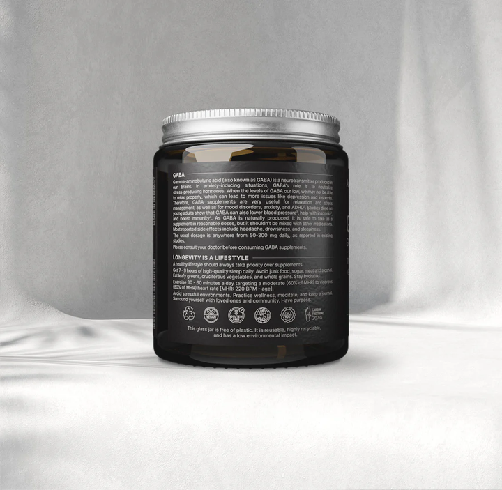 Black supplement jar with silver lid on a gray background
