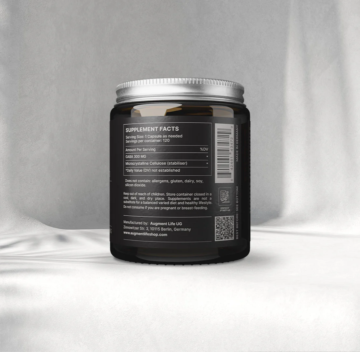 Black supplement container with label on a gray background