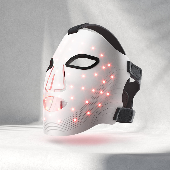White mask with red LED lights on a gray background