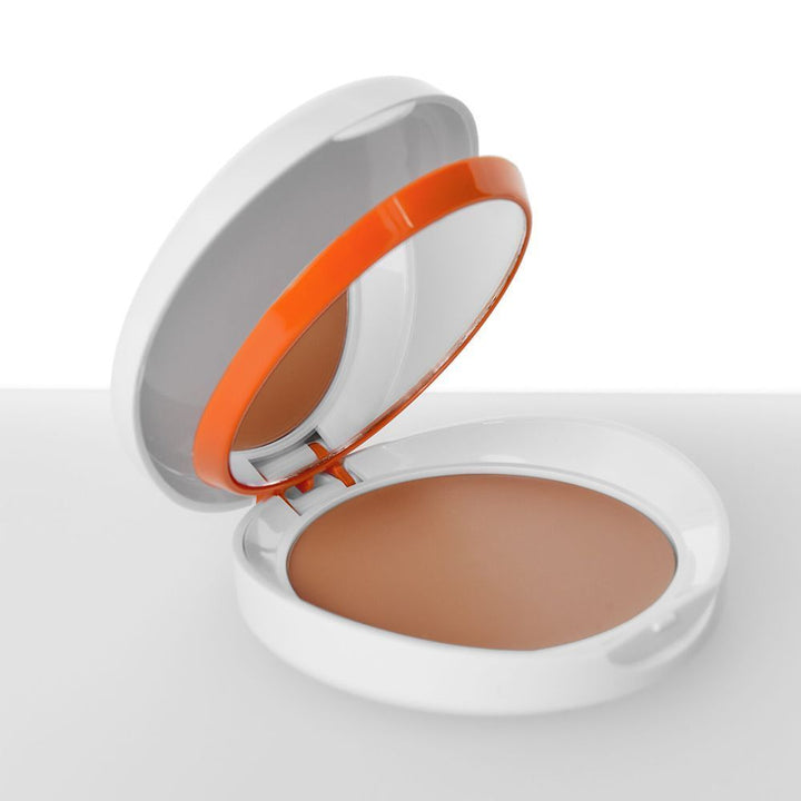 Compact powder with a mirror and orange accent on a white background brown color