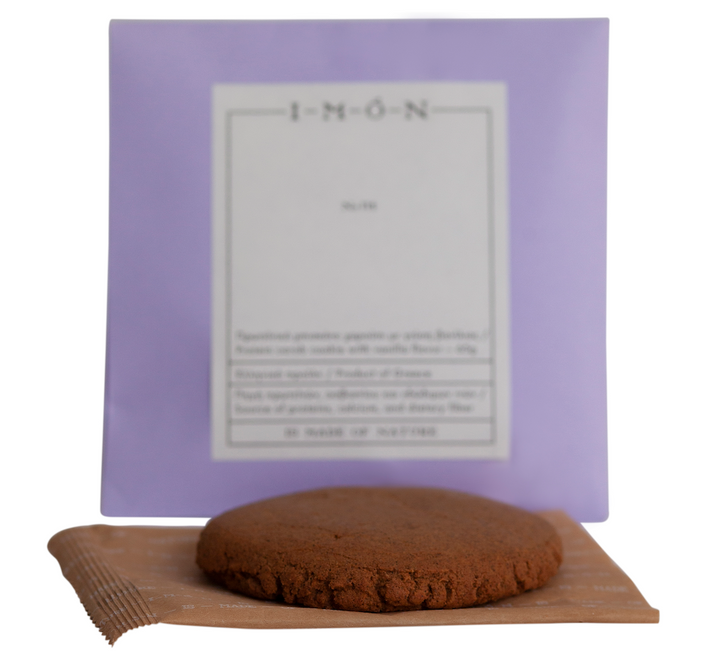 Chocolate cookie on a wooden board with a purple box in the background