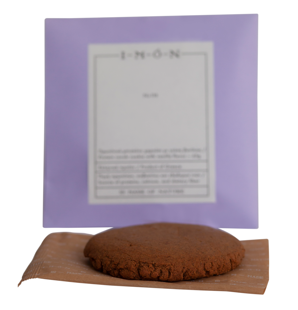 Brown round product on a brown paper bag with a purple card featuring text in the background