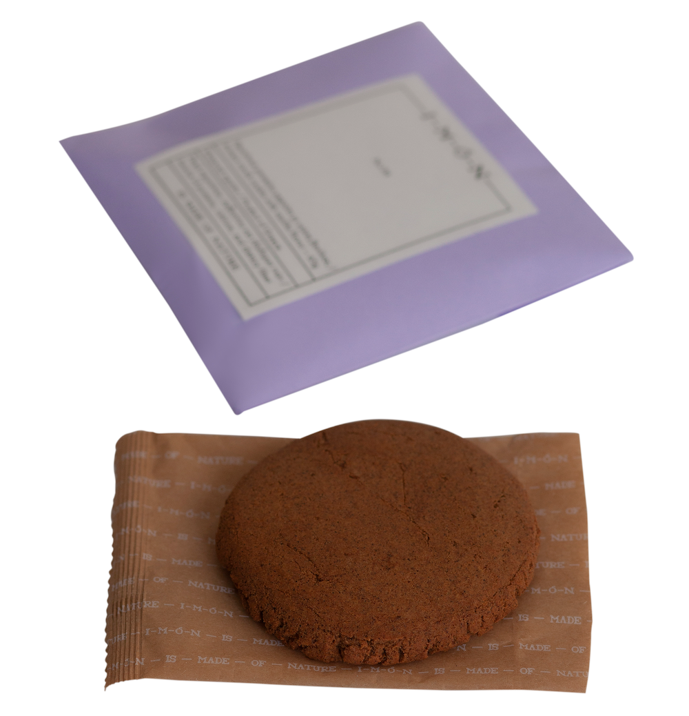 Chocolate cookie on brown paper with a purple envelope in the background