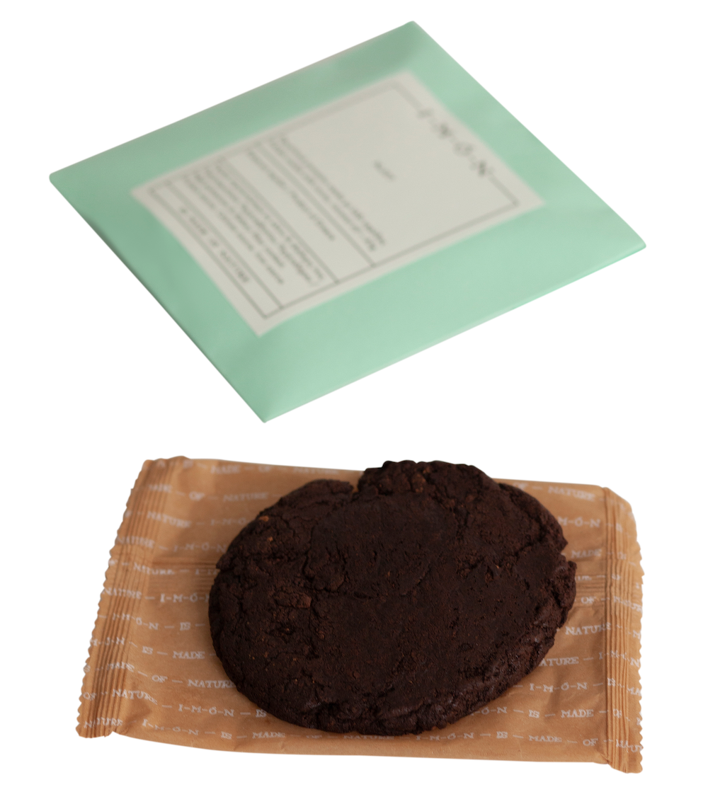 Chocolate cookie on a brown paper bag with a green label in the background