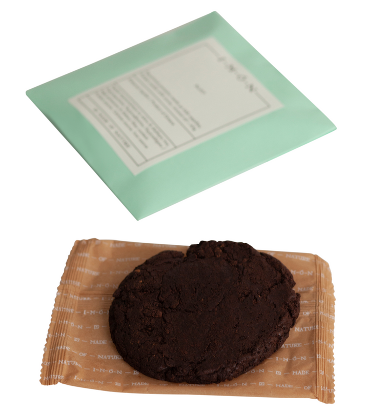 Chocolate cookie on a brown paper bag with a green label in the background