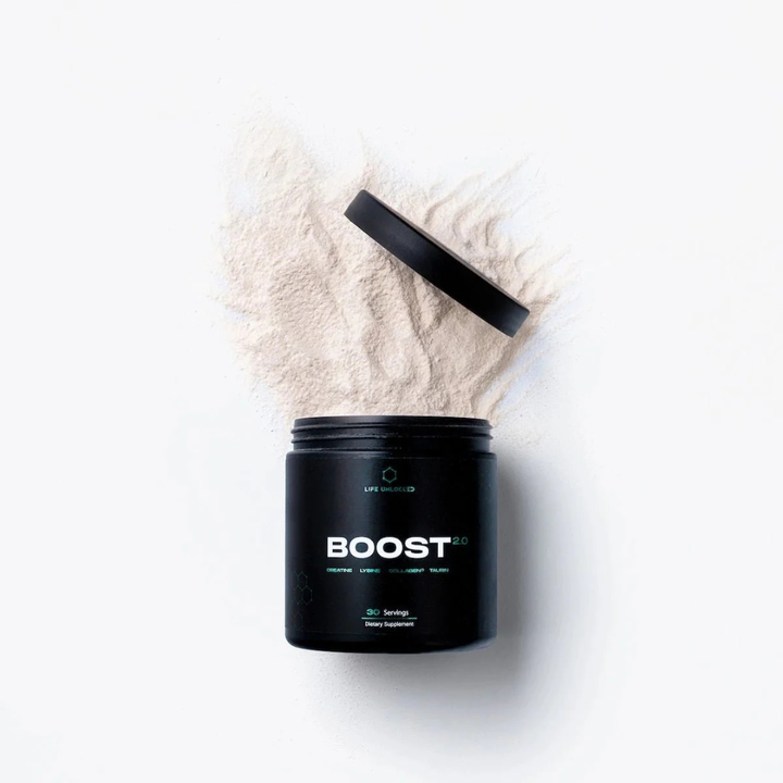 Black container labeled 'BOOST' with white powder spilling out on a white background