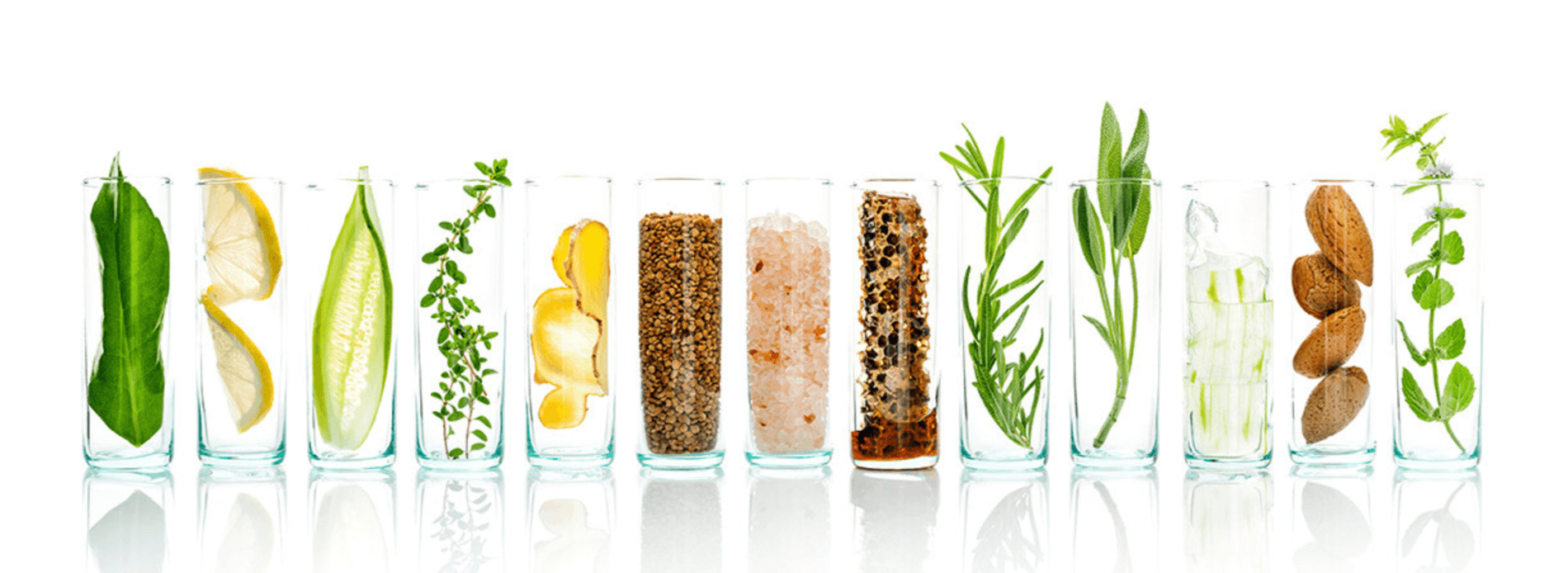 Glass test tubes with lemon, mint, seeds, ginger, salt and others symbolizing natural wellness and purity.