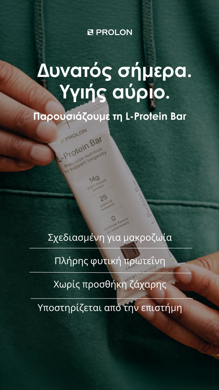 Person holding a L-Protein Bar packaging with Prolon branding on a green background